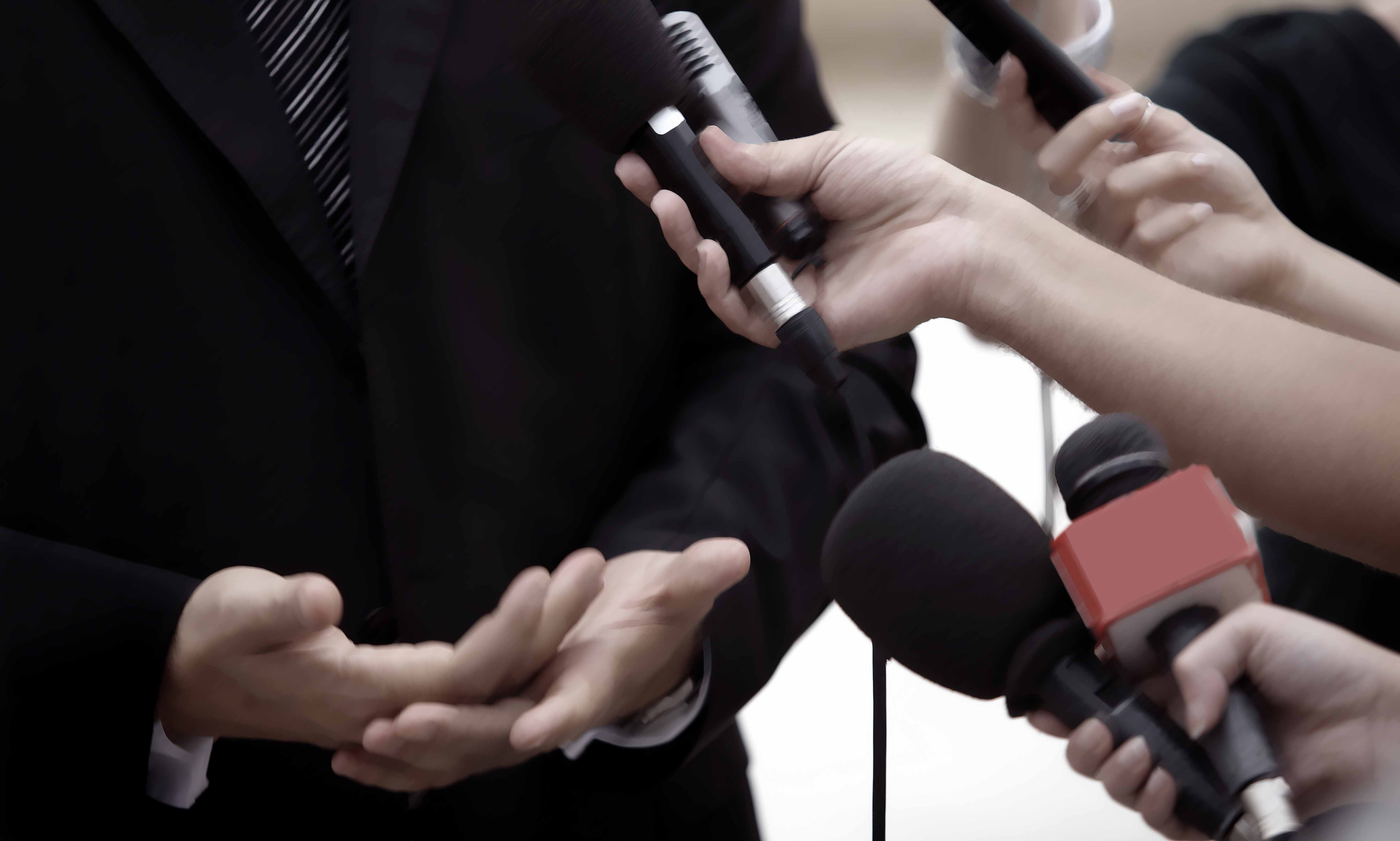 close up of conference meeting microphones and businessman